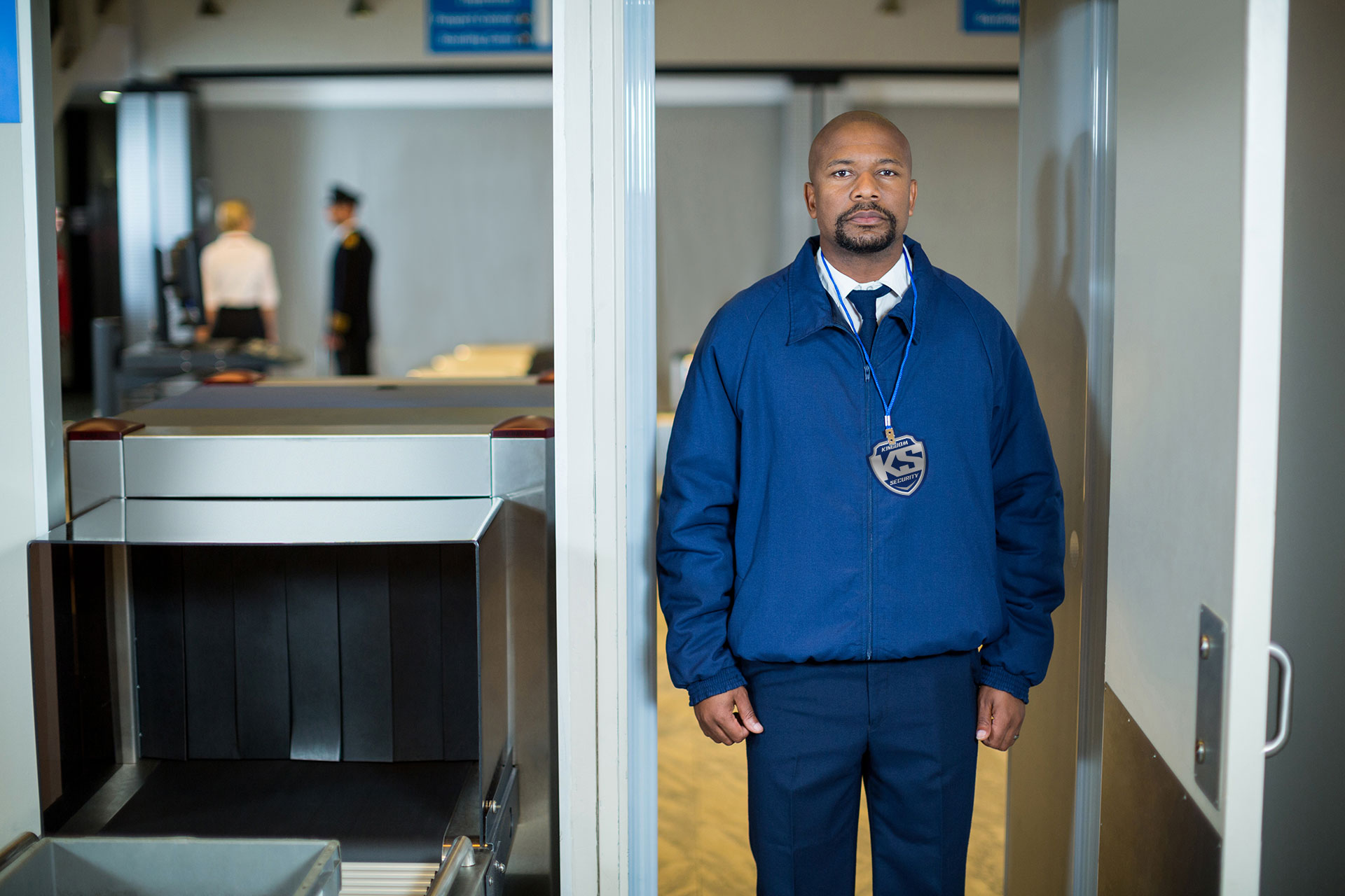 airport-security-officer-standing-metal-detector-door